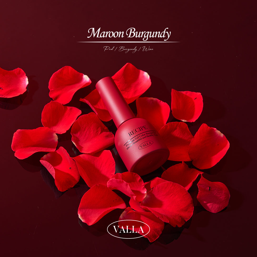Red rose petals surrounding Valla Maroon Burgundy gel bottle for a romantic aesthetic.