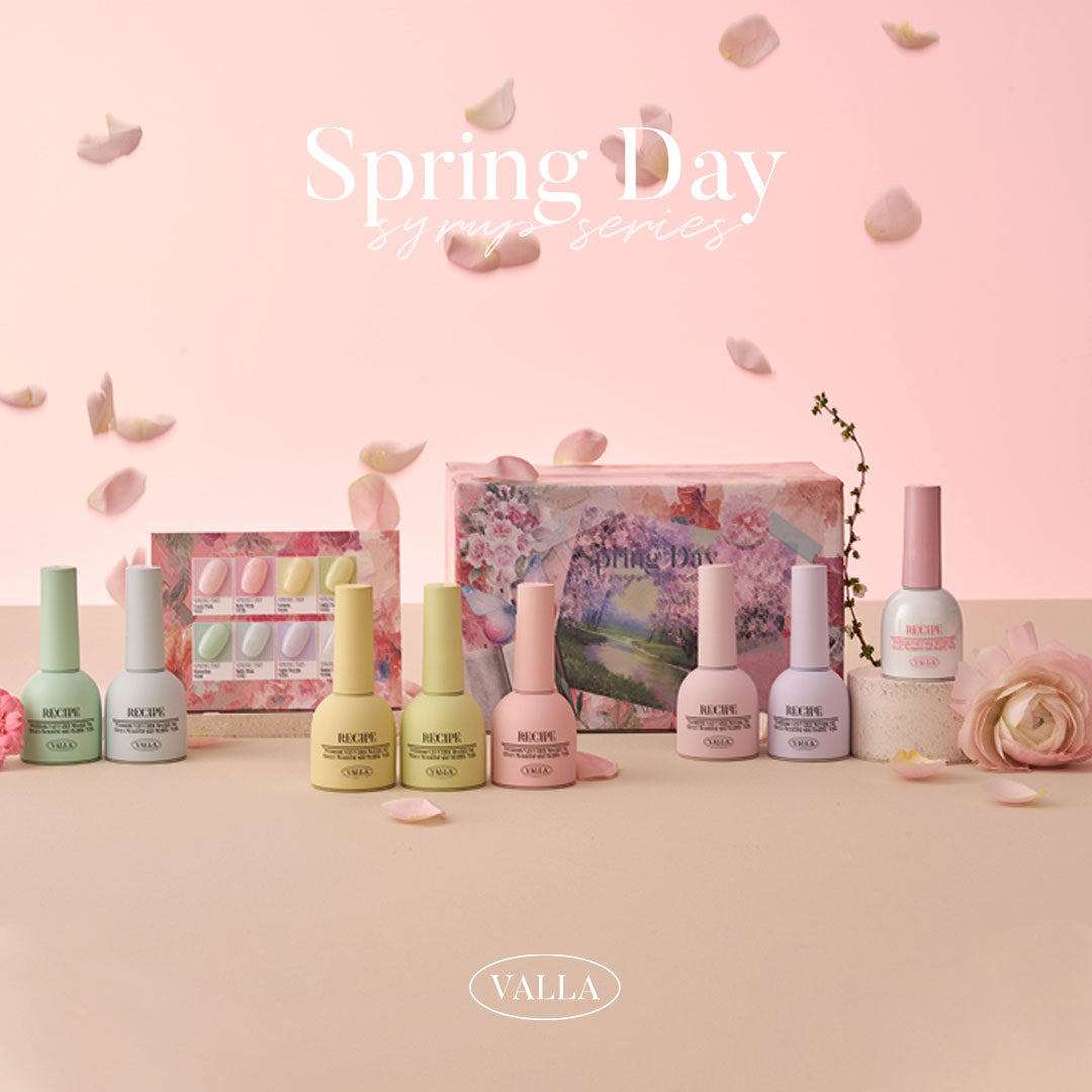 Soft pastel gel polish bottles surrounded by petals for Spring Day launch.