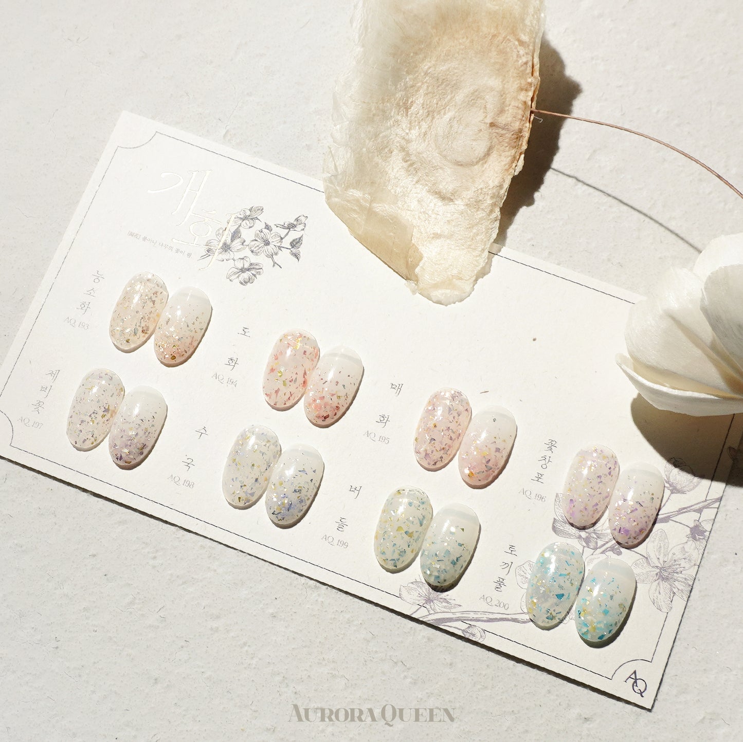 Flatlay showing pastel floral gel polishes in natural light