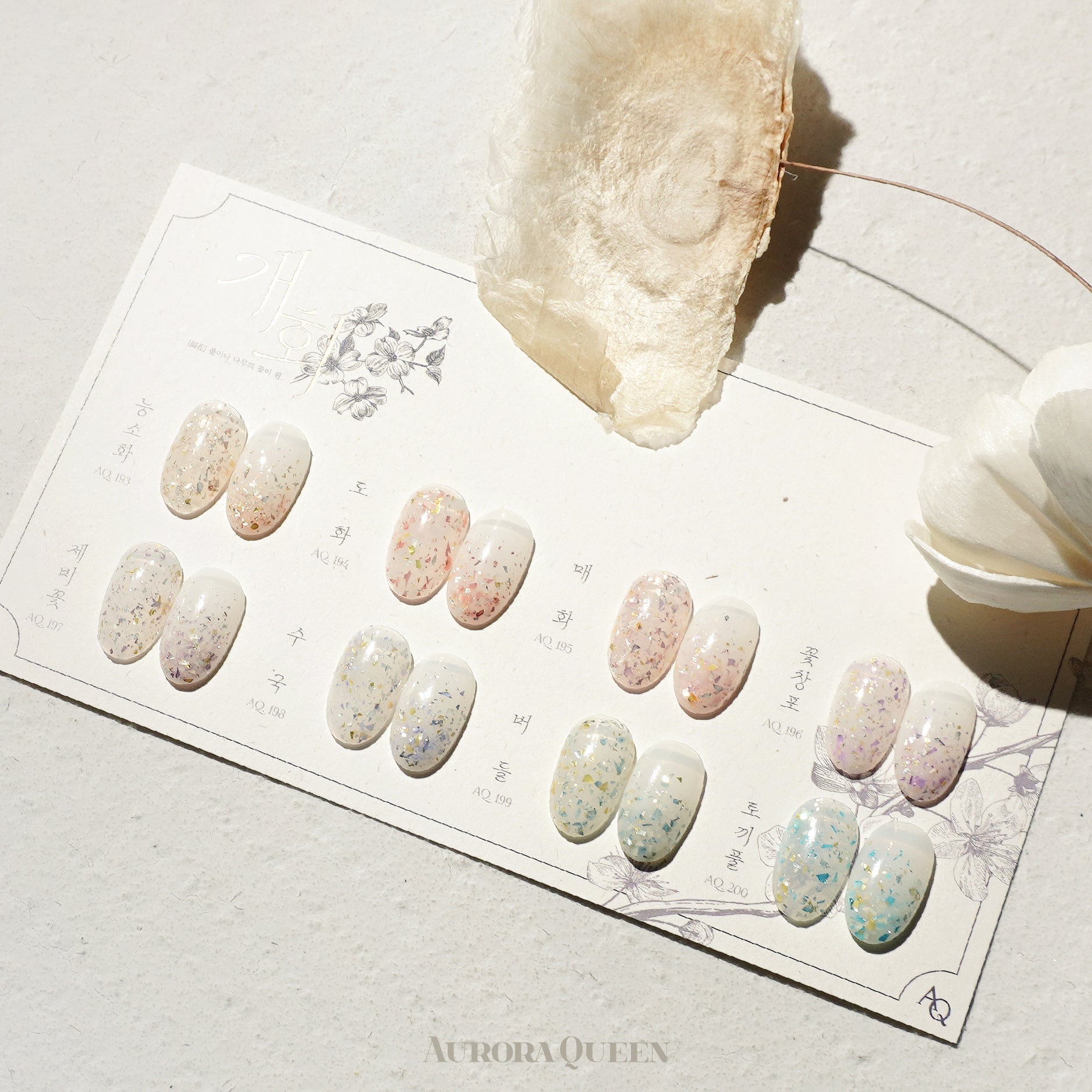Flatlay showing pastel floral gel polishes in natural light