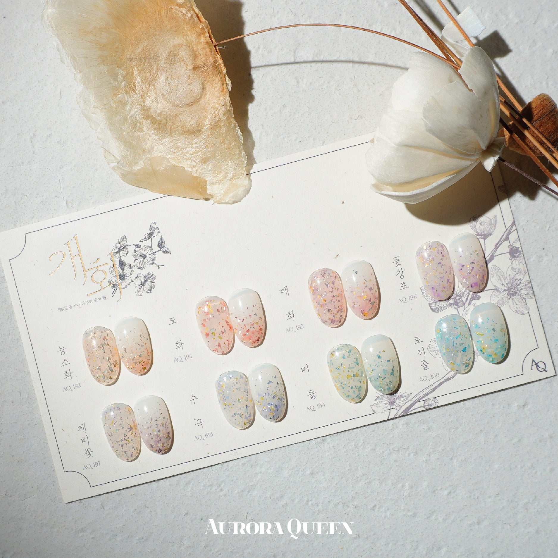 Flatlay showing pastel floral gel polishes in natural light