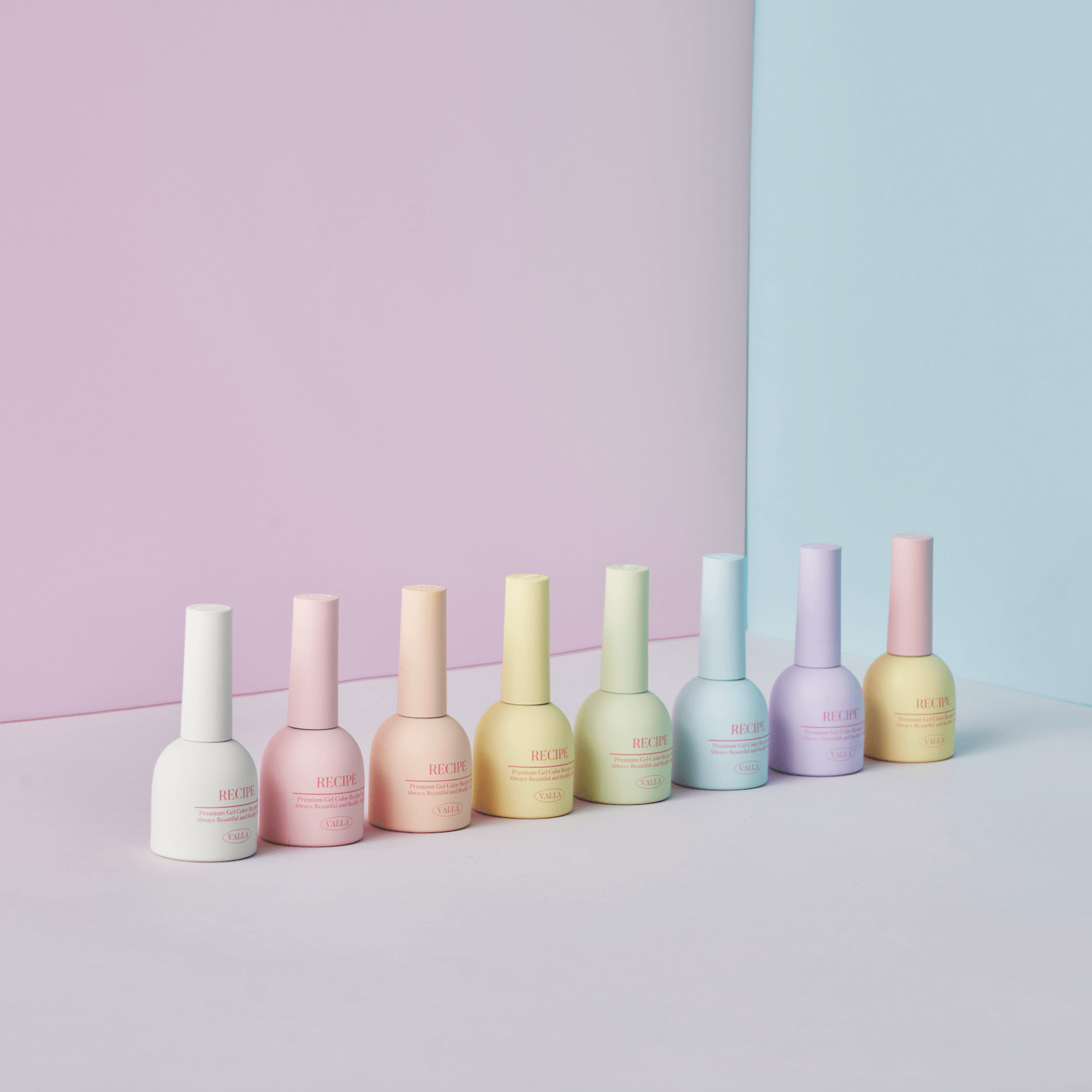 Flatlay of Valla Gel Cotton Pastel bottles on a striped pastel background – trendy product shoot